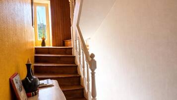A wooden staircase with white balusters leading to a landing.