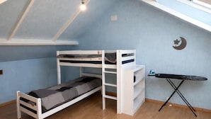 A loft bedroom with a bunk bed, a desk, and a small ironing board. - Namaste Duplex Gare Nantes  (Nantes)