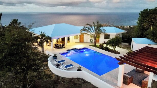 A modern house with a swimming pool, a patio, and a view of the ocean. - Ultimate USVI Views overlooking Caribbean & Salt River Bay Nat'l EcoPreserve (Christiansted)
