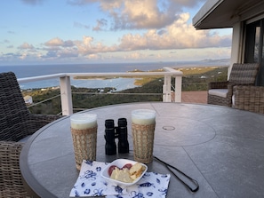Enjoy a refreshing drink and snack on the balcony, taking in the breathtaking ocean views and distant islands.
