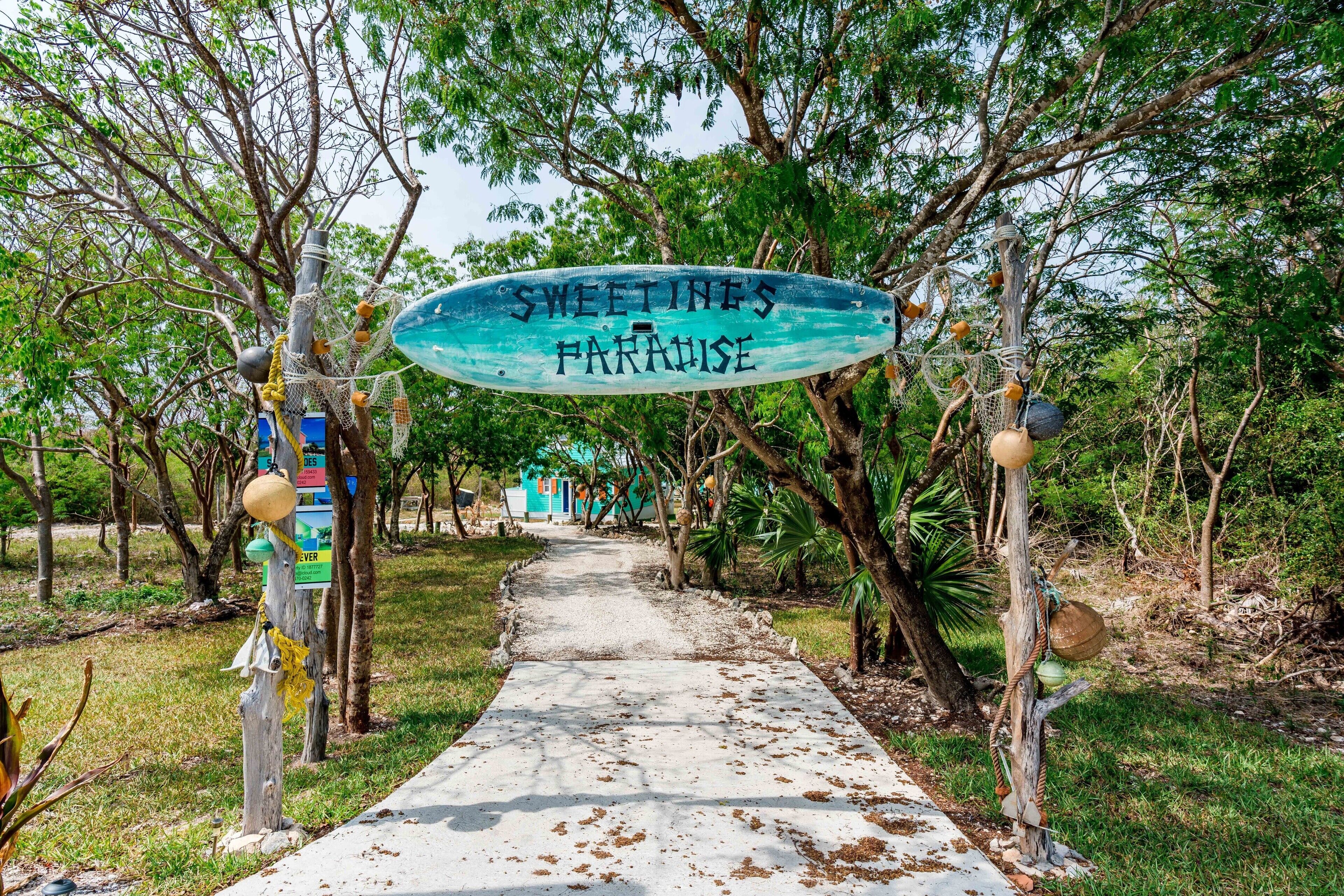 A pathway leading to a building with a sign reading "SWEETINES PARADISE".