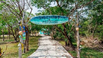 A pathway leading to a building with a sign reading "SWEETINES PARADISE".
