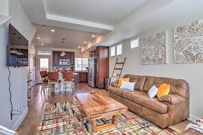 Relax in this stylish living area with a comfortable sofa, coffee table, and abstract art pieces.