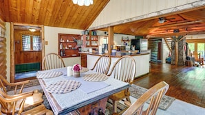 A wooden interior with a dining area, kitchen, and living space. - Saranac Lake Cabin w/ Deck: Pets Welcome! (Saranac Lake)