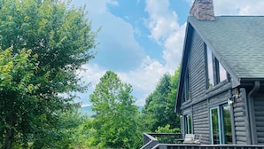 A log cabin with a deck and a stone chimney. - The Rocking A Frame - modern meets cozy. (Danbury)