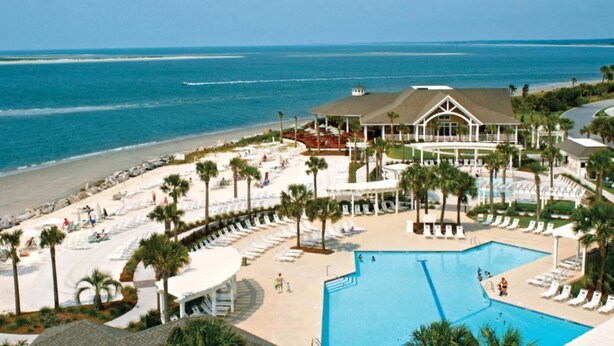 A resort with a large pool, beach area, and ocean view. - Beautiful Sunsets--Beachfront, Club Amenity Cards included with price! (Seabrook Island)