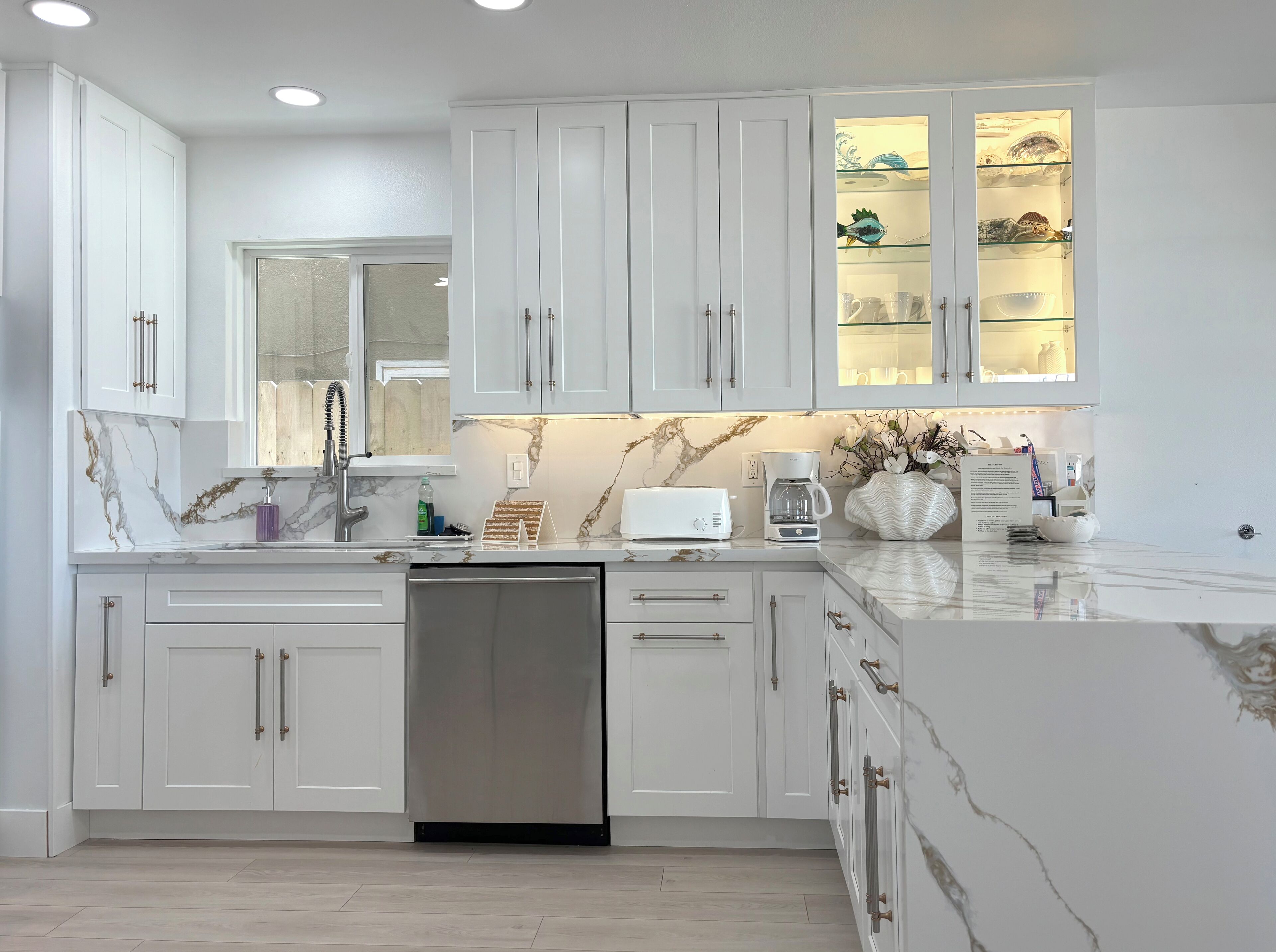 In cabinet lighting and spacious peninsula with bar seating.