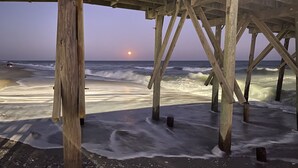 A wooden pier structure with visible beams and supports.