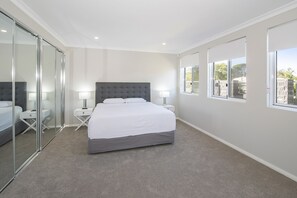 Enjoy a restful stay in this cozy room with a large bed, bedside tables, and a glass partition wall.