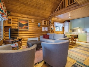 A log cabin interior with a living room, a kitchen, and a dining area. - Metsätähti by Interhome (Puolanka)