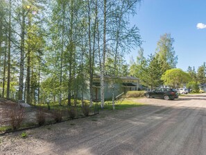 A residential area with a house, a parked car, and a gravel driveway. - Rantalinna 2 by Interhome (Ruokolahti)