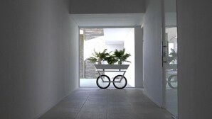 A modern hallway with a minimalist design, leading to an outdoor area with a planter cart. - Hotel And Spa Alfandega Da Fe (Alfandega da Fe)