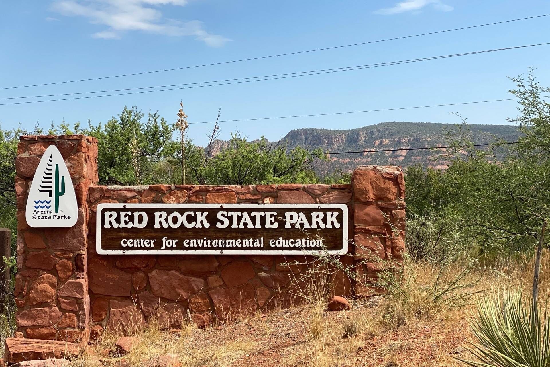 A sign for Red Rock State Park, indicating it is a center for environmental education.