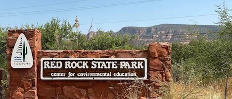 A sign for Red Rock State Park, indicating it is a center for environmental education.