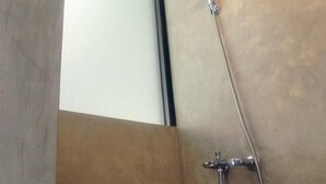 A shower with a handheld showerhead and a wall-mounted faucet. - Dparagon Gajah Mada (Jakarta)