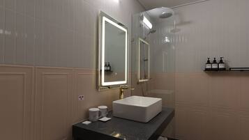 A modern bathroom with a large mirror, a white sink, and a shower area.