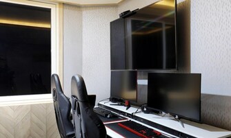 A gaming setup with two monitors, a keyboard, and a mouse.