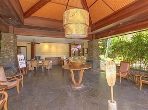 Experience the blend of traditional and modern design in our spacious lobby, featuring a high ceiling, comfortable seating areas, and a reception desk.