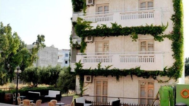 A multi-story building with a pool area, outdoor seating, and a green garden. - Maria Apartments (Hersonissos)