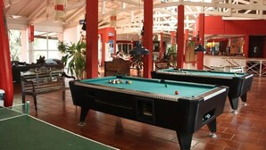 A pool hall with two pool tables, a ping pong table, and a bar area. - Beer Hotel Iguazu Hostel (Puerto Iguazú)