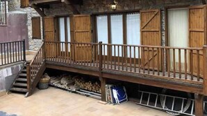 A two-story building with wooden balconies and stone walls. - Bellver Center (Bellver de Cerdaña)