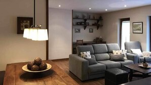 A modern living room with a grey sofa, a coffee table, and a lamp. There are shelves with decorative items and a framed picture on the wall. - Bellver Center (Bellver de Cerdaña)