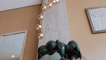 A sculpture with a hanging light fixture.