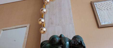 A sculpture with a hanging light fixture.