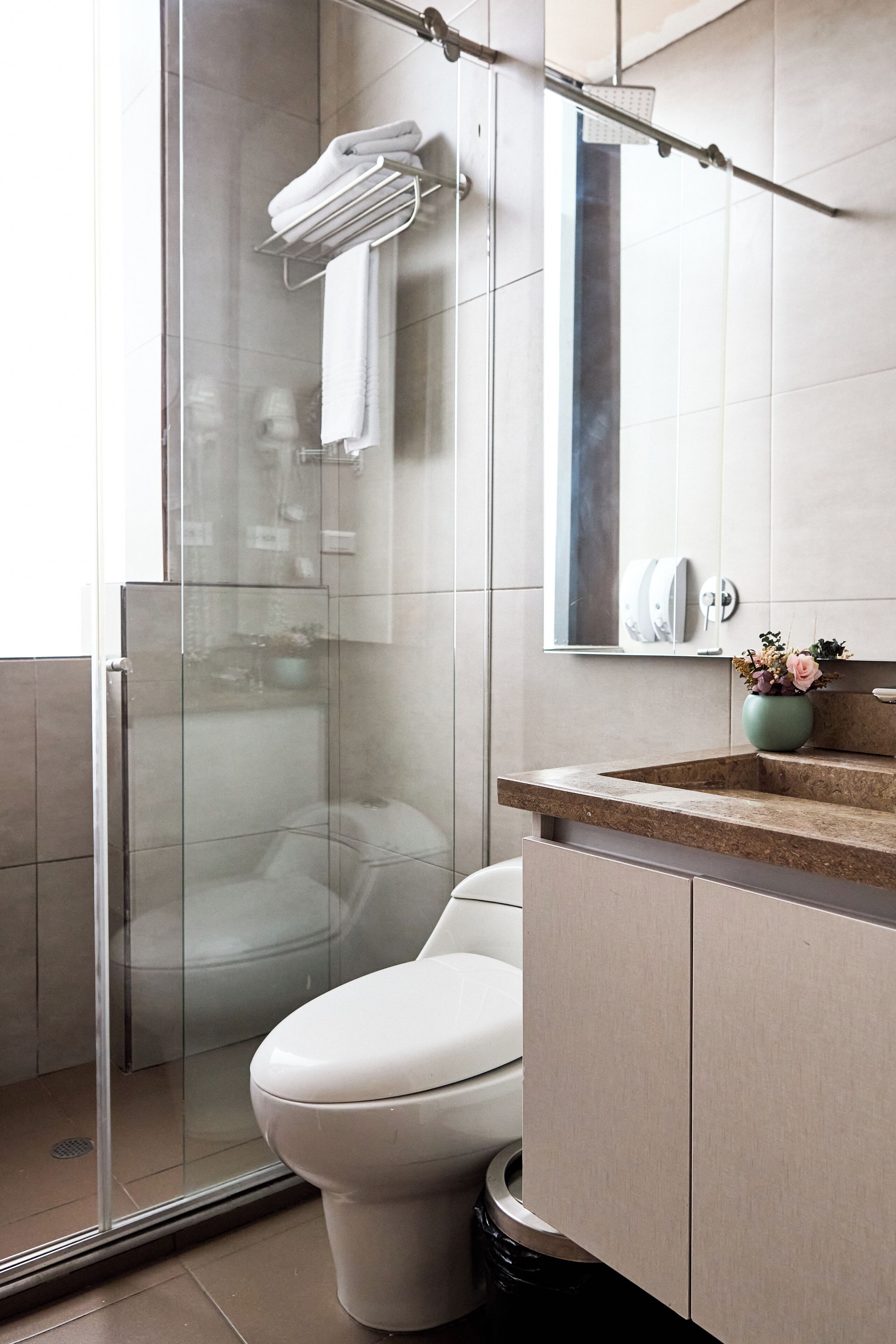 traditional studio | bathroom | shower, rainfall showerhead, towels, soap