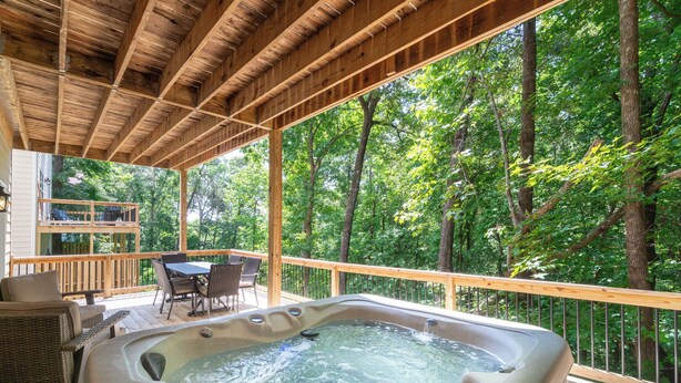 A hot tub on a wooden deck with a view of trees. - Helen, Georgia ★ Yonah Mtn, Hot Tub, Games + Grill (Helen)