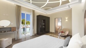 A modern hotel room with a large bed, a vanity with a mirror, a wardrobe, and a sliding glass door leading to a balcony. - Sorrento Dream Villa (Sorrento)