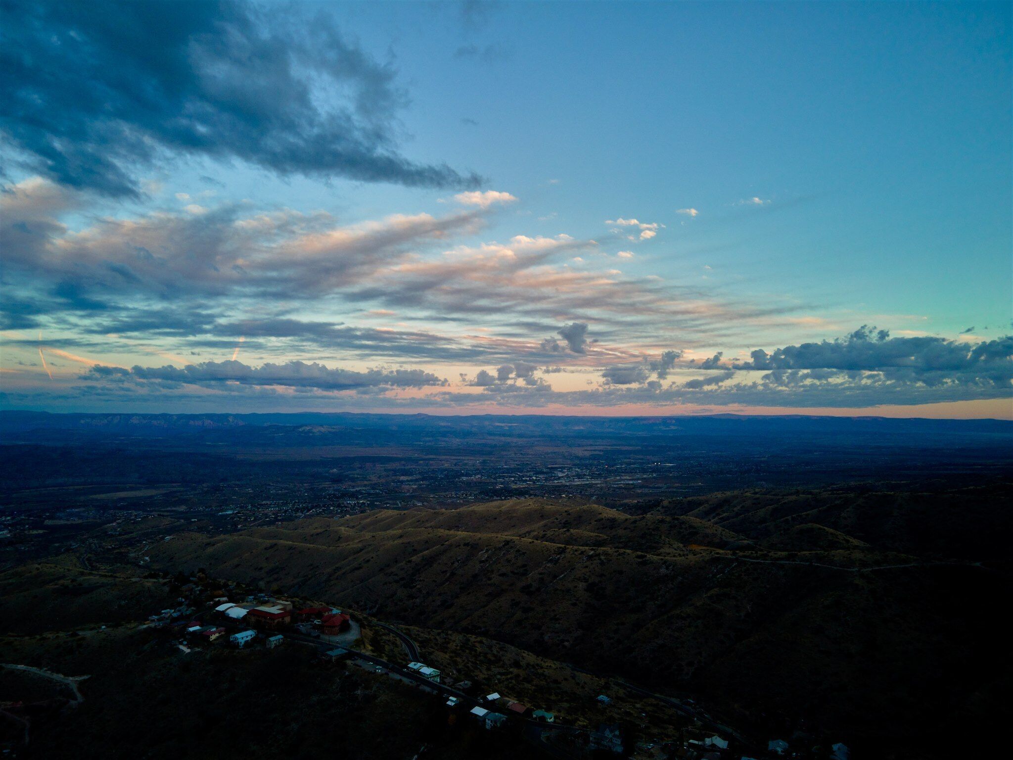 A panoramic view of a mountainous landscape with a town nestled in the valley below.
