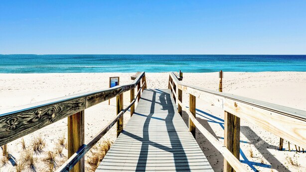 A wooden boardwalk leading to a beach with clear blue water. - Perdido Sun #514 | Pool, Water Views, Beachfront! (Perdido Key)