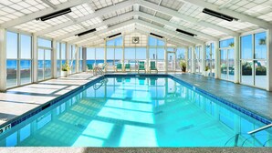 An indoor swimming pool with clear views of the ocean through large windows. - Perdido Sun #514 | Pool, Water Views, Beachfront! (Perdido Key)