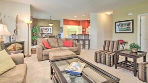 A living room with a sofa, armchairs, a coffee table, and a dining area with chairs and a table. - 4 Mi to Bethany Beach: Sunny Escape w/ Porches! (Ocean View)