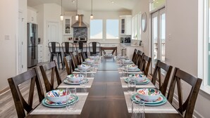 A modern kitchen with a central island, stainless steel appliances, and ample natural light. - Luxurious Gulf-front home with views, porches, and beach access - Moasis (Dauphin Island)