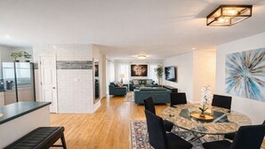A modern living space with a kitchen, dining area, and seating area. - Heart of Atlanta 4BR Home – 1 Block to Beltline & Krog Street Market (Atlanta)