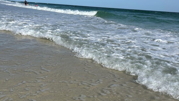 A beach with waves, clear sky, and footprints in the sand. - 2 Br 1 Bath Condo in Gulfshores, AL, 2 min walk to the Beach, Pool and Fishing (Gulf Shores)