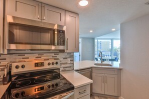 Fridge, microwave, oven, stovetop - LUXURY OCEANFRONT 2BR Condo, Pool & Hot Tub, Game Rooms, Great Views (Daytona Beach Shores)