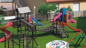 A playground with multiple slides and climbing structures. - House (Tropea)