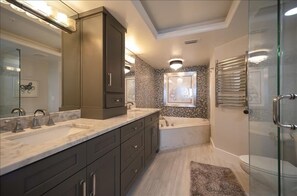 A modern bathroom with a large vanity, a freestanding bathtub, and a glass shower enclosure. - 20th Floor Luxury in this 2 bedroom 2 bath condo - Unit 2005 Towers 10 (Daytona Beach Shores)