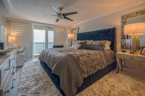 A bedroom with a large bed, a ceiling fan, a dresser, and a nightstand. - 20th Floor Luxury in this 2 bedroom 2 bath condo - Unit 2005 Towers 10 (Daytona Beach Shores)
