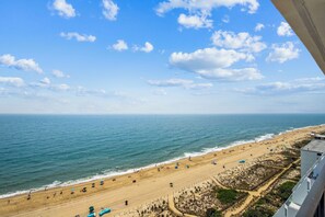 Blick auf einen Strand mit blauem Himmel, Sand und Meer.