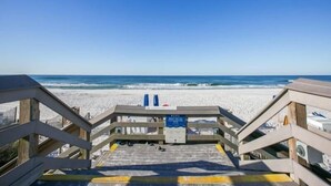 A wooden boardwalk leading to a sandy beach with a clear blue sky. - Steps from the beach! Pool, Pickleball, and Tennis Courts! (Miramar Beach)