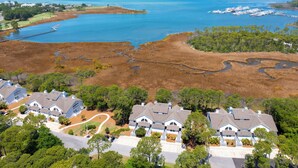 A residential area with houses, a dock, and a large body of water.
