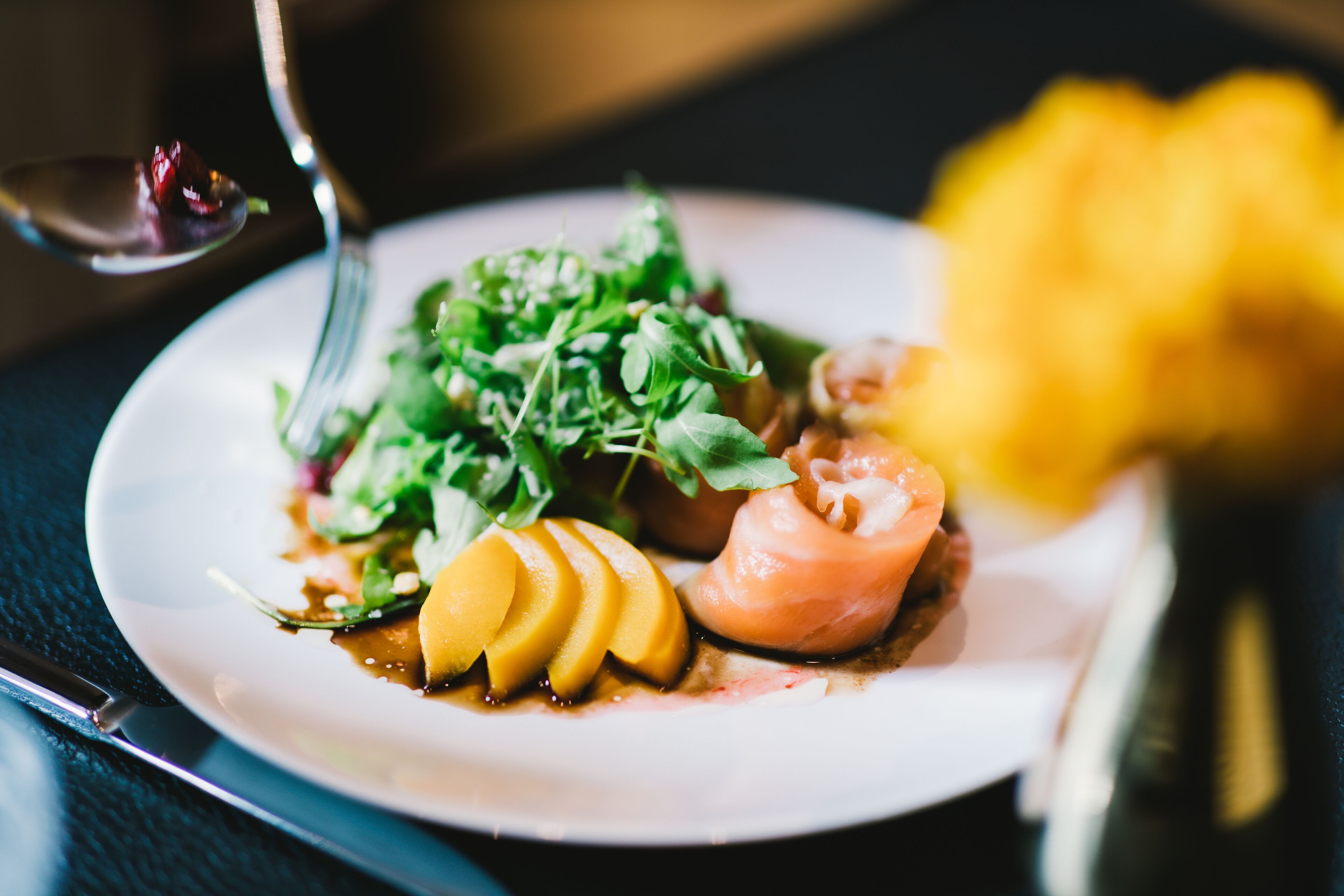 A plate of food with a fork and a spoon.