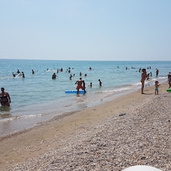 Private beach, black sand, sun loungers, beach umbrellas