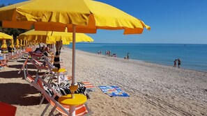 Private beach, black sand, sun-loungers, beach umbrellas