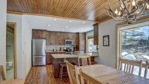 A modern kitchen with wooden cabinets, stainless steel appliances, and a large island. - Ski in/Ski Out 100 yards, Masive Views, On Shuttle Route, Hot Tub, Fireplace (Breckenridge)