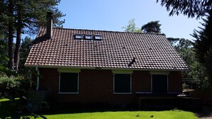 A two-story brick house with a tiled roof, a chimney, and a well-maintained lawn. - House (Condette)